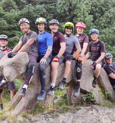 group of cyclists on an animal sculpture