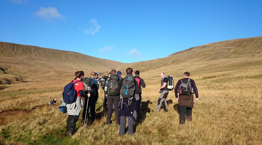 A group of people walking in the hills