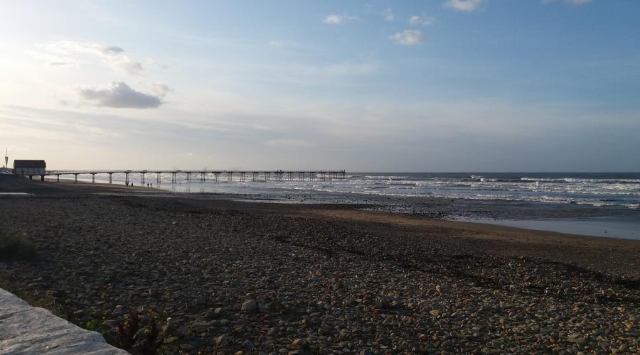 Sun setting along the sandy shoreline