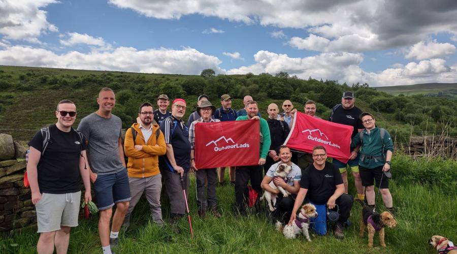 Guys on walk in countryside with a red flag