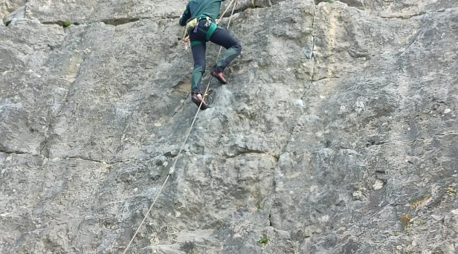 a climber on a sheer cliff