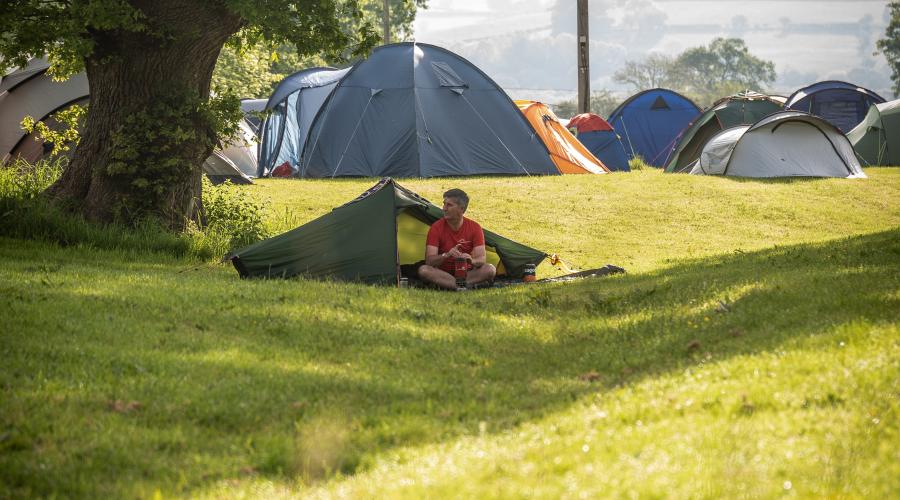Camper at his tent