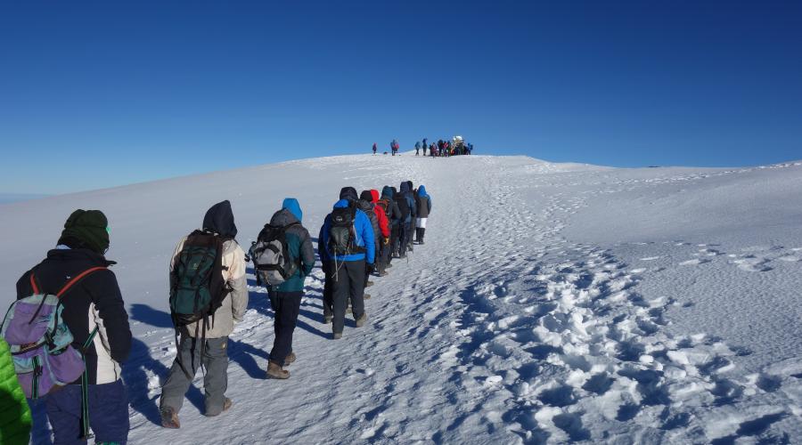 Walking towards the summit in snow 