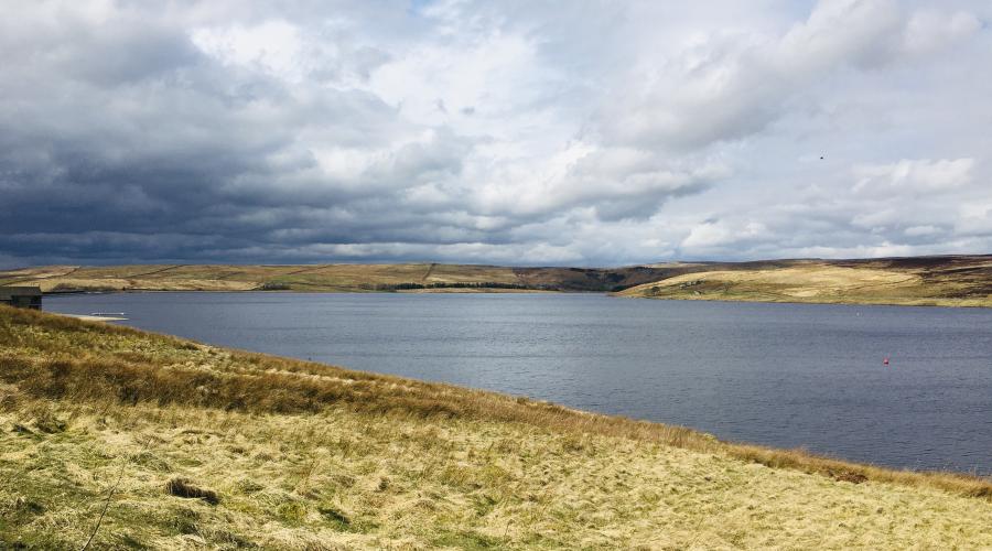 Reservoir view with cloudy sky above