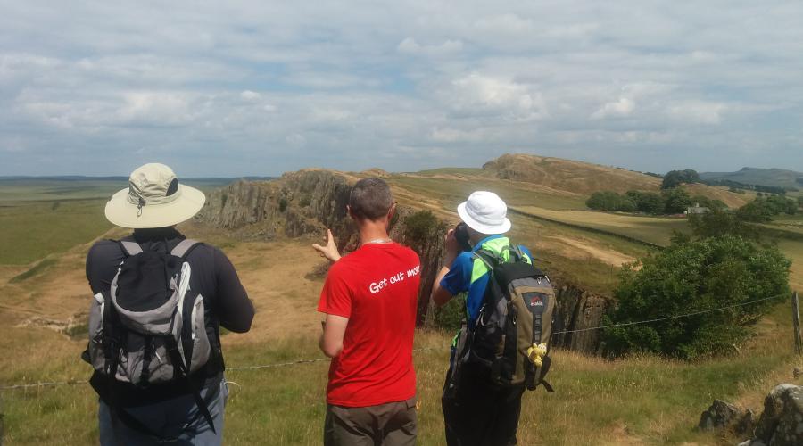 Hadrians Wall view with OutdoorLads assessing the vista