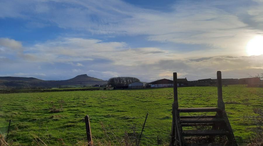 Sun setting over a ladder style looking to Roseberry Topping hill