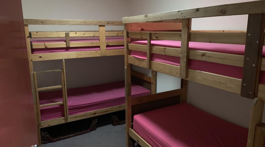 A bedroom with two bunkbeds