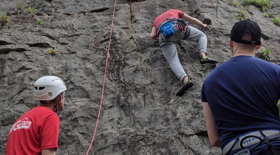 a group of climbers and belayers