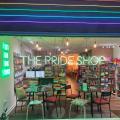 The Pride Shop Nottingham - nighttime view of a cafe / shop with neon words