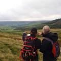 Two members navigating looking into thr hills