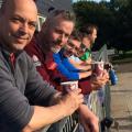 men on a balcony drinking coffee