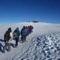 Walking towards the summit in snow 