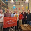 8 guys with flag at Flamingos LGBT cafe Leeds