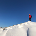 Man on top of snowy mountain