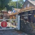 A curious yard with sheds, a railway style gate and an ad for Bovril