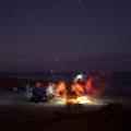 Friends around a bonfire on the beach