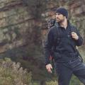 Bearded man wearing hiking clothes on a mountain