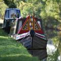 Canal boat sailing along canal