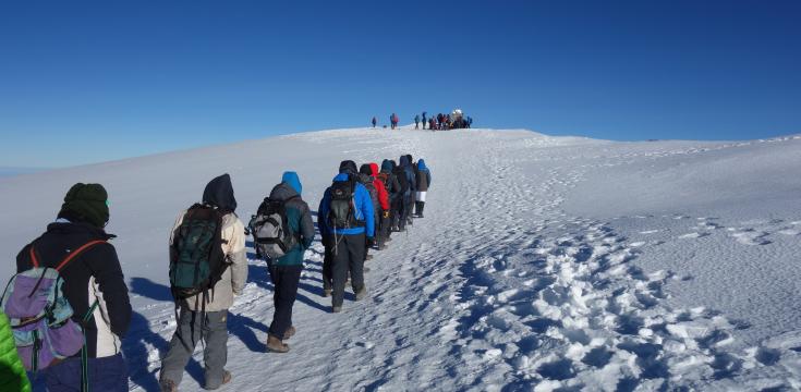 Walking towards the summit in snow 