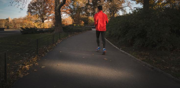 Image of a man running though a park
