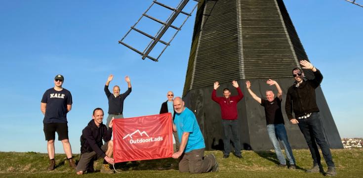 Socially distanced group in front of a windmill