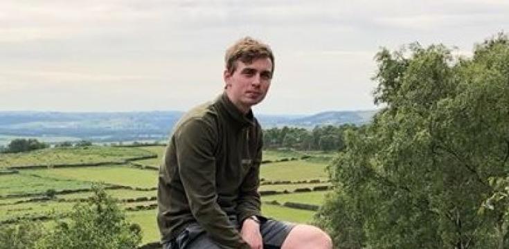 Close up of Dan sitting on a rock